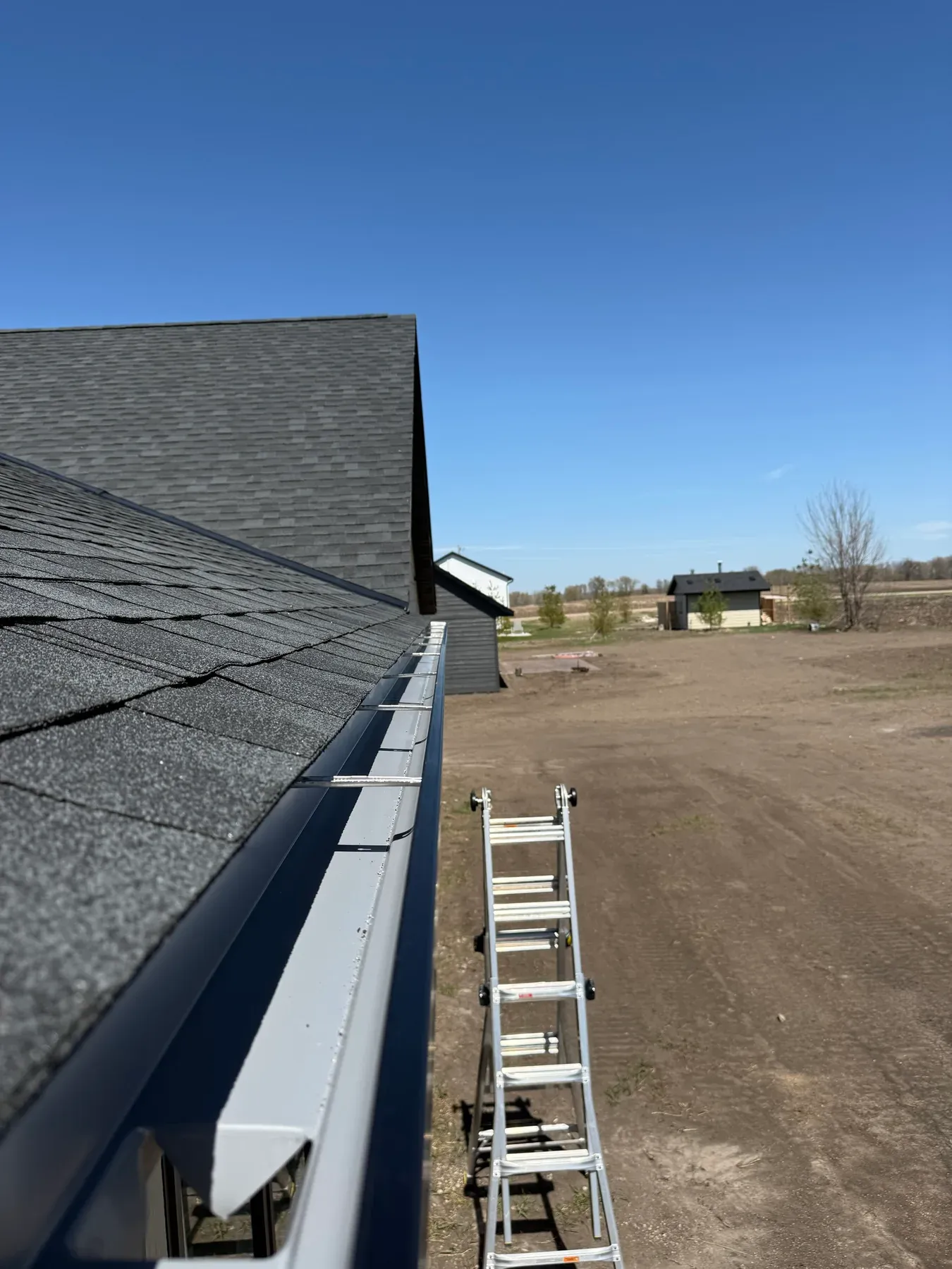 White seamless gutter following a roof eave