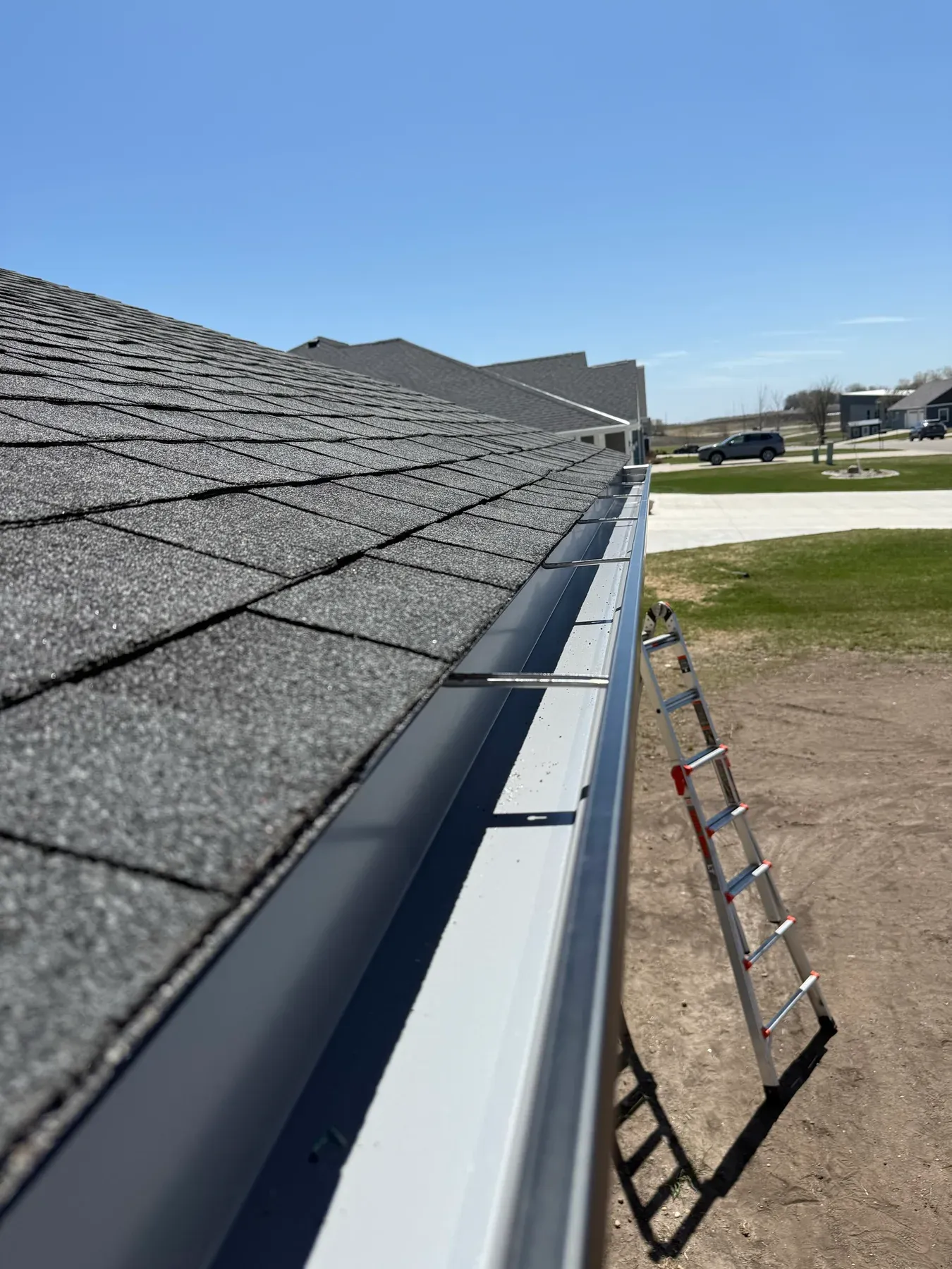 Fresh seamless gutter installed along the eave of a new home