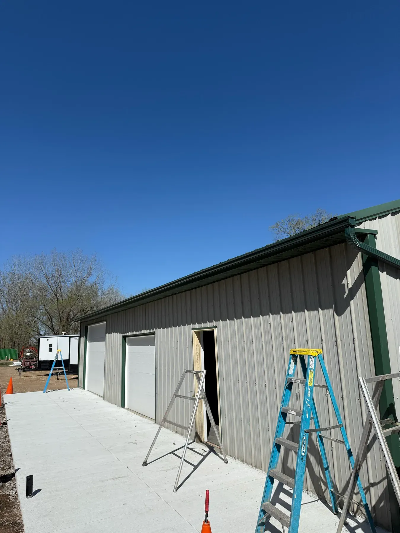 Green gutter installed on a metal shop exterior